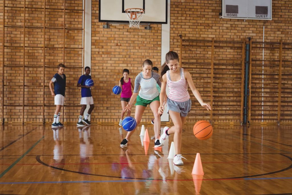 Kids run beginner's drills they learned from Backyard Fun Zone on a basketball court